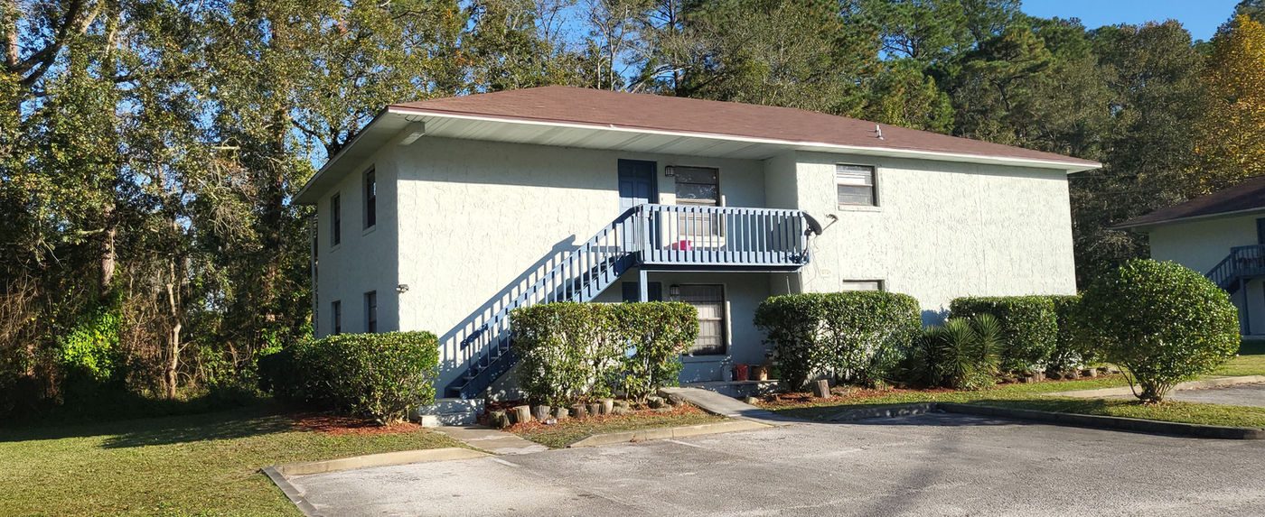 White two-story building with an exterior stair in Hyde Park