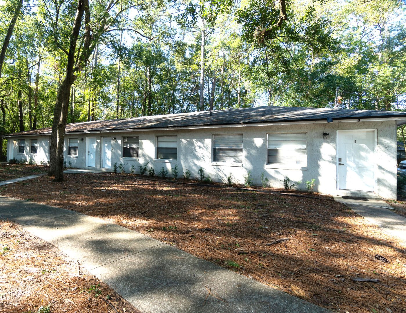 Long single-story building under trees at Ortega Farms
