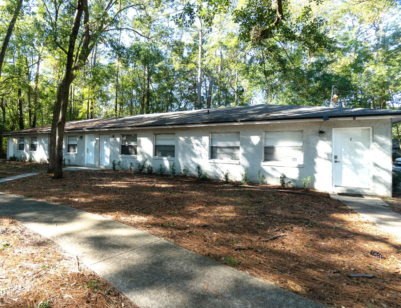 Long single-story building under trees at Ortega Farms